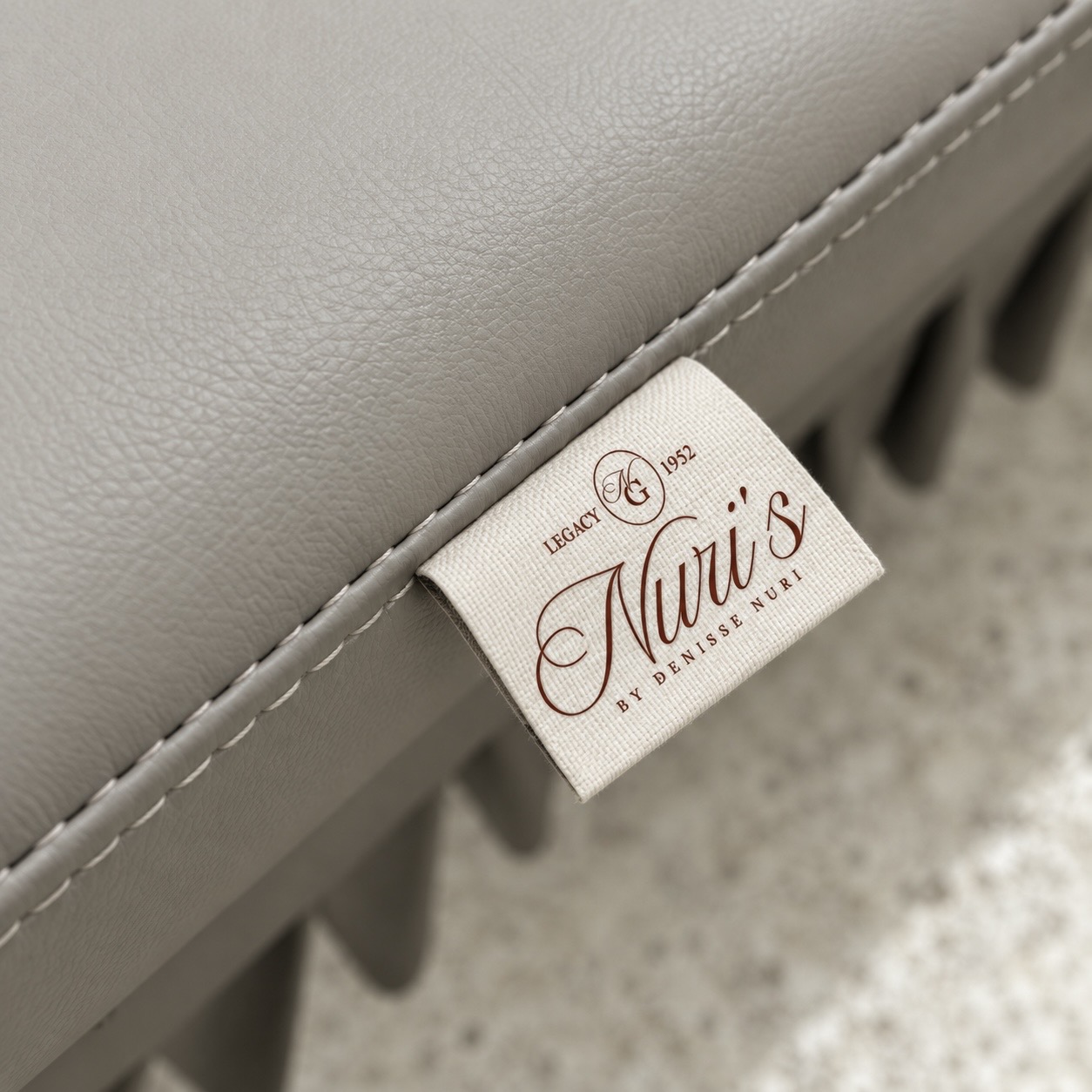 Nuri's Glam branded label on custom upholstered salon furniture